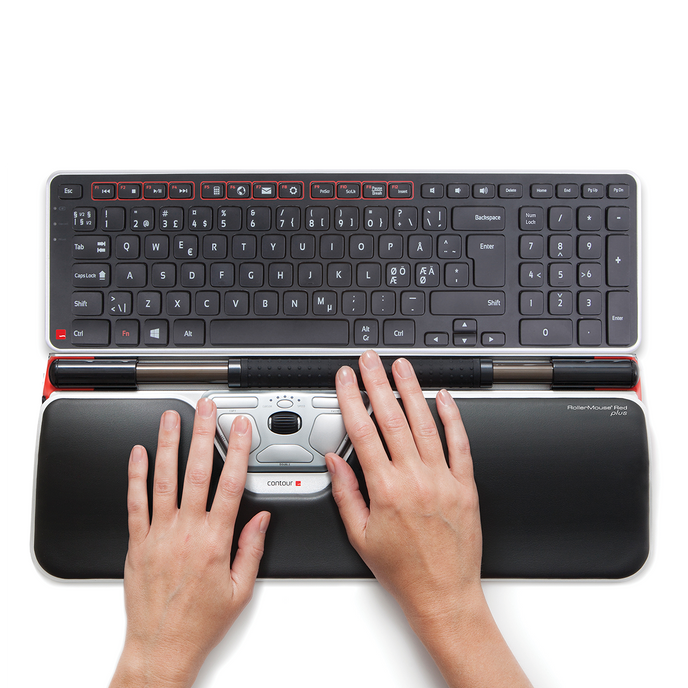 Female hands hovering over RollerMouse Red and Balance Keyboard